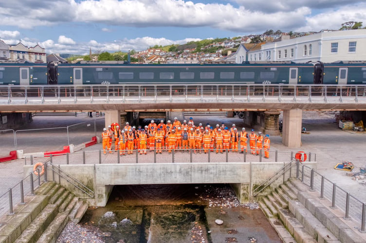 Contractors working on the Dawlish sea wall celebrate the opening. 