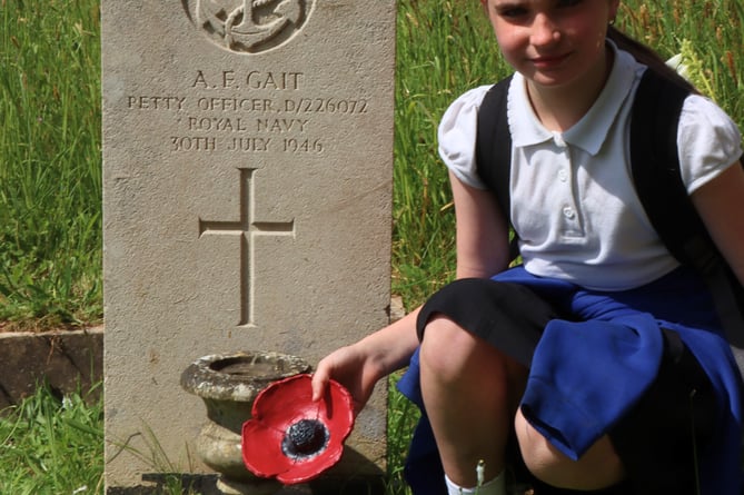 Jasmine Packwood pays tribute to great grandfather Albert Fred Gait at Teignmouth cemetery 