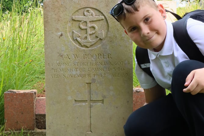Harry Parsons at the grave of his. great grandfather Albert William Boorer at Teignmouth Cemetery 