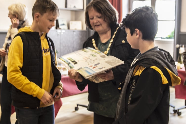 Mayor of Dawlish Cllr Lin Goodman-Bradbury with two students from Collège Saint-Trémeur presenting letters and A3 posters for their penfriends in Dawlish College