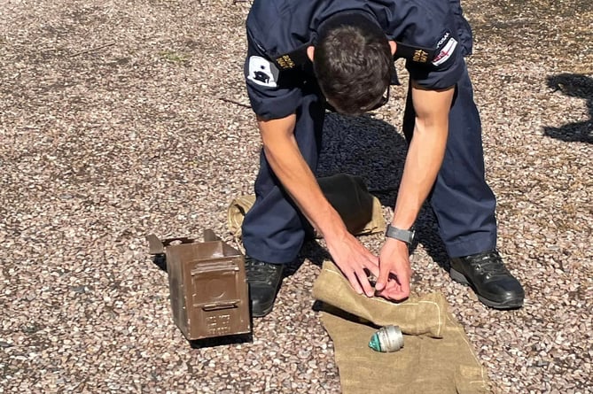 Royal Navy bomb disposal expert with the WW1 shell detonator fuses. Photo Ann Thorp 