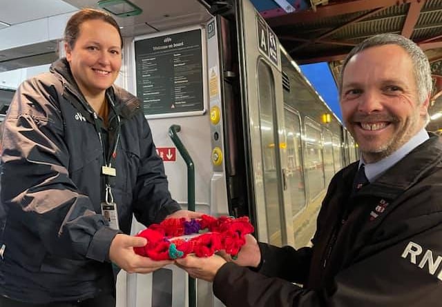 Teignmouth RNLI hand over the specially made wreath to GWR on the Poppy Train. Photo Teignmouth RNLI 