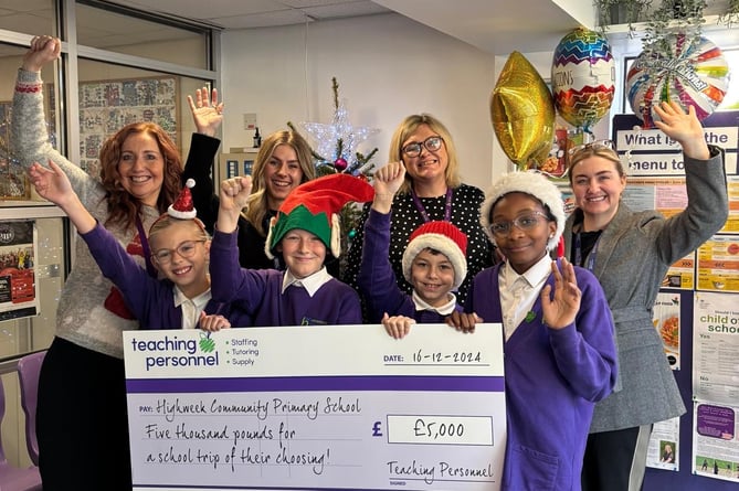 Children from Highweek Community Primary School celebrate winning a cash grant for their school trip.