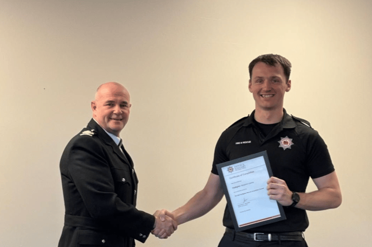 Buckfastleigh Fire Station's newest team member, Ben Leaney, right, receiving his Recruit Award